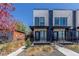 Modern townhomes with drought-resistant landscaping, set behind a wooden fence for added privacy at 1318 Yates St, Denver, CO 80204