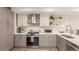 Stylish kitchen features stainless steel appliances, gray cabinetry, and plenty of counter space at 1318 Yates St, Denver, CO 80204