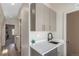 Hallway with modern cabinets, sink and faucet, and view of a room down the hall at 1318 Yates St, Denver, CO 80204