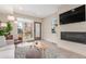 Bright living room with fireplace, large windows, and comfortable seating at 1318 Yates St, Denver, CO 80204