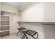 Bright walk-in closet features built-in shelves and hanging rods for optimal storage at 1318 Yates St, Denver, CO 80204