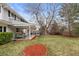 Backyard showing a covered patio with outdoor seating, a dining area, and mature trees at 3966 S Magnolia Way, Denver, CO 80237