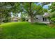 Lush backyard featuring a swing hanging from a mature tree, perfect for outdoor recreation and relaxation at 3966 S Magnolia Way, Denver, CO 80237