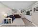 Inviting basement with comfortable seating, built-in shelving, and ample lighting at 3966 S Magnolia Way, Denver, CO 80237