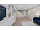 Finished basement with wood-look floors, white built-ins, and staircase access at 3966 S Magnolia Way, Denver, CO 80237