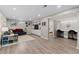 Finished basement features built-in shelving, luxury vinyl plank flooring, and flex space for office or lounging at 3966 S Magnolia Way, Denver, CO 80237