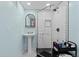Modern bathroom featuring a pedestal sink, subway tile shower, and stylish accents at 3966 S Magnolia Way, Denver, CO 80237