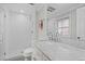 Bright bathroom featuring a glass-enclosed shower, marble countertop, and modern fixtures at 3966 S Magnolia Way, Denver, CO 80237
