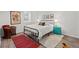 Cozy bedroom featuring warm decor, a patterned rug, and ample natural light at 3966 S Magnolia Way, Denver, CO 80237