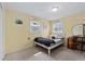 Cozy bedroom featuring two windows, a white bed frame, and neutral-toned carpet at 3966 S Magnolia Way, Denver, CO 80237