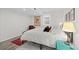 Charming bedroom with a bed, a patterned rug, and a side table with a lamp at 3966 S Magnolia Way, Denver, CO 80237