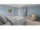 Bedroom featuring carpeted floor, white bed, window, and sitting chair at 3966 S Magnolia Way, Denver, CO 80237