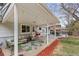 Covered patio with comfortable seating, an outdoor rug, string lights, and a dining area at 3966 S Magnolia Way, Denver, CO 80237