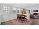 Cozy dining area with natural light from windows and doorway, complemented by hardwood flooring and seating at 3966 S Magnolia Way, Denver, CO 80237