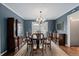 Elegant dining room with hardwood floors, sophisticated furniture, and a stylish chandelier for meals at 3966 S Magnolia Way, Denver, CO 80237