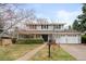 Traditional two-story home featuring manicured landscaping and an attached two-car garage at 3966 S Magnolia Way, Denver, CO 80237