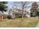 Charming two-story home with an attached garage, showcasing a well-maintained lawn at 3966 S Magnolia Way, Denver, CO 80237