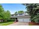 Lovely two-story home with a two-car garage, complemented by lush greenery and a well-manicured lawn at 3966 S Magnolia Way, Denver, CO 80237