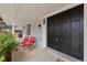 Inviting front porch with red chairs, a black front door and well-kept landscaping at 3966 S Magnolia Way, Denver, CO 80237
