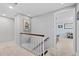 Upstairs hallway leading to a bedroom, with neutral walls, carpet, and staircase at 3966 S Magnolia Way, Denver, CO 80237