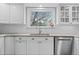 Updated kitchen featuring bright white cabinetry, stainless steel dishwasher, and under cabinet lighting at 3966 S Magnolia Way, Denver, CO 80237
