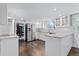 Bright, remodeled kitchen with white cabinets, stainless steel appliances, and hardwood floors at 3966 S Magnolia Way, Denver, CO 80237
