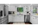 Updated kitchen with white cabinets, stainless steel appliances, and a view of the backyard at 3966 S Magnolia Way, Denver, CO 80237