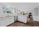 Remodeled kitchen with hardwood floors, white cabinets, and views into the living room at 3966 S Magnolia Way, Denver, CO 80237