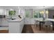 Updated kitchen with bright white cabinets, hardwood floors, and a breakfast nook at 3966 S Magnolia Way, Denver, CO 80237