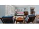 Bright living room boasts a bay window, comfortable seating, and a retro-inspired rug with hardwood floors at 3966 S Magnolia Way, Denver, CO 80237