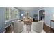 Inviting blue living room with ample seating, plantation shutters, and hardwood floors at 3966 S Magnolia Way, Denver, CO 80237