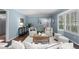 Stylish blue living room with neutral furniture, hardwood floors, and plenty of natural light at 3966 S Magnolia Way, Denver, CO 80237