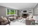 Bright living room with a brick fireplace, built-in shelving, and comfortable seating at 3966 S Magnolia Way, Denver, CO 80237