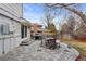 Outdoor patio with a dining table, grill, and a landscaped backyard at 3966 S Magnolia Way, Denver, CO 80237