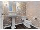 Stylish powder room features elegant pedestal sink and floral wallpaper, creating a chic space at 3966 S Magnolia Way, Denver, CO 80237