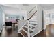 Beautiful staircase with wooden steps and white railings leads to the upper level of the home at 3966 S Magnolia Way, Denver, CO 80237