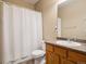 Neutral bathroom featuring a shower with curtain, toilet, vanity and mirror at 10162 Bluffmont Ln, Lone Tree, CO 80124