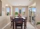 Cozy dining area featuring a wooden table and chairs with natural light pouring in from the windows at 10162 Bluffmont Ln, Lone Tree, CO 80124