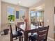 Dining room featuring a dark wood table with leather chairs and sliding glass doors to patio at 10162 Bluffmont Ln, Lone Tree, CO 80124