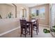 Small dining room featuring a dark wood table with leather parson chairs at 10162 Bluffmont Ln, Lone Tree, CO 80124