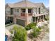 Charming two-story townhome featuring a brick facade, a second story balcony, and lush landscaping at 10162 Bluffmont Ln, Lone Tree, CO 80124
