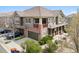 Exterior elevation view of a 2-story townhome with a 2-car garage and front yard at 10162 Bluffmont Ln, Lone Tree, CO 80124