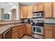 Cozy kitchen featuring stainless steel appliances, oak cabinets, and a convenient layout at 10162 Bluffmont Ln, Lone Tree, CO 80124