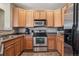 Well-lit kitchen showcasing stainless steel appliances and ample cabinet space at 10162 Bluffmont Ln, Lone Tree, CO 80124