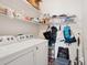 Laundry room with white washer and dryer, storage shelves and hanging space at 10162 Bluffmont Ln, Lone Tree, CO 80124
