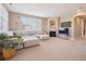 Inviting living room with a sectional sofa, fireplace, and lots of natural light at 10162 Bluffmont Ln, Lone Tree, CO 80124