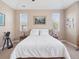 Main bedroom featuring a king bed, overhead lighting, side tables, and windows at 10162 Bluffmont Ln, Lone Tree, CO 80124