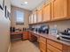 Bright home office featuring wood cabinets, drawers, work surfaces, and carpeted flooring at 10162 Bluffmont Ln, Lone Tree, CO 80124