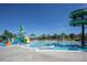 Community pool area featuring water slides, splash pad, and shaded seating for residents at 10162 Bluffmont Ln, Lone Tree, CO 80124