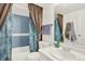 Cozy bathroom featuring a shower-tub combo, white vanity, and modern fixtures at 10211 Ura_ Ln # 101, Thornton, CO 80260